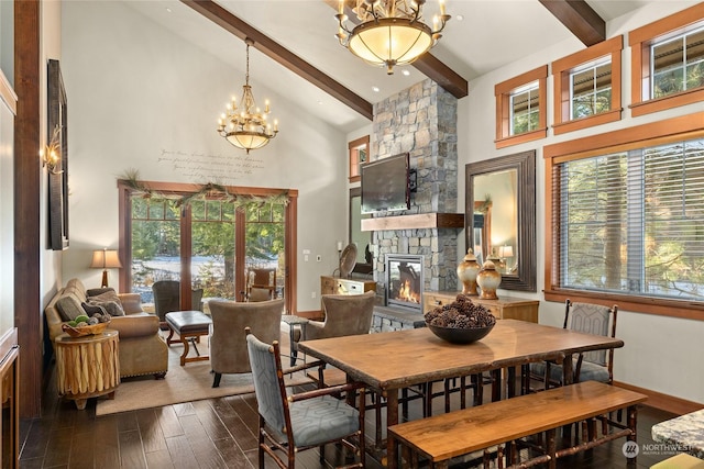 dining room with a wealth of natural light, dark hardwood / wood-style flooring, and beamed ceiling