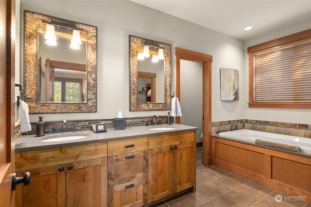 bathroom featuring a tub to relax in, tile patterned floors, and vanity