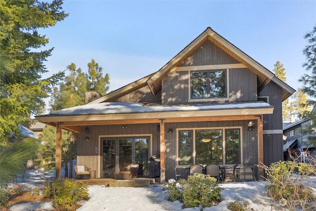 back of property with a porch