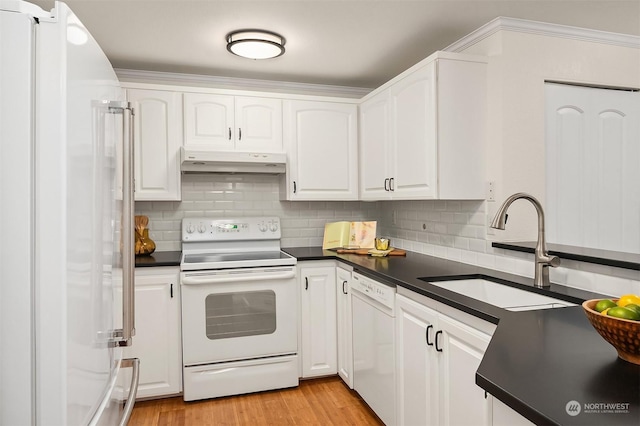 kitchen featuring white cabinetry and white appliances