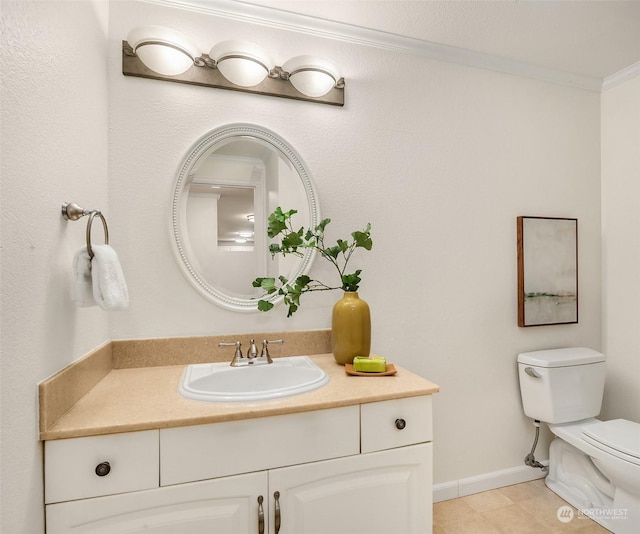 bathroom with vanity, toilet, ornamental molding, and tile patterned floors