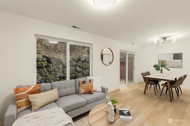 living room featuring light hardwood / wood-style floors and a healthy amount of sunlight