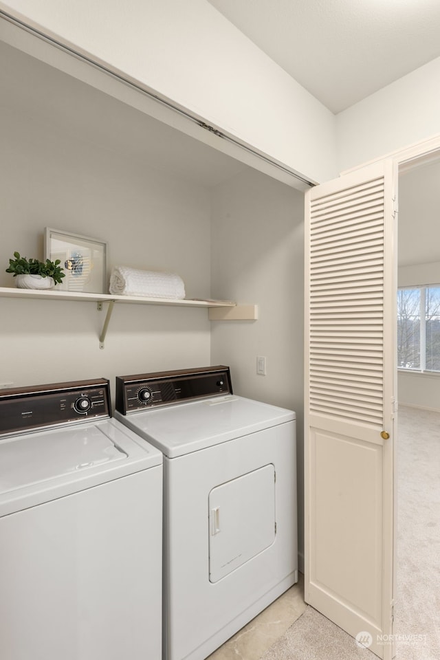 laundry area featuring light colored carpet and washing machine and clothes dryer