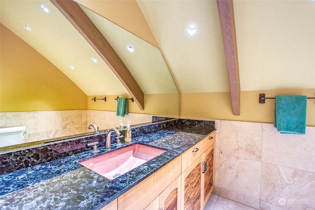 bathroom featuring vanity, tile patterned flooring, lofted ceiling with beams, and tile walls