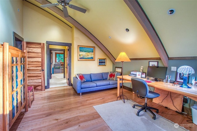 office featuring ceiling fan, vaulted ceiling with beams, and light wood-type flooring