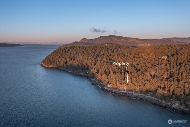 aerial view at dusk with a water and mountain view