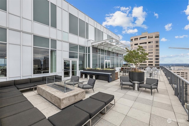 view of patio featuring an outdoor living space with a fire pit