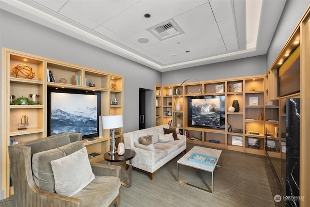 carpeted living room with a tray ceiling