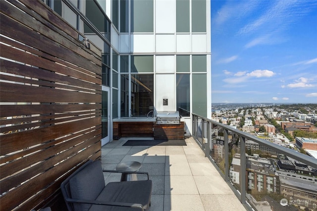 view of patio / terrace featuring a balcony and a grill