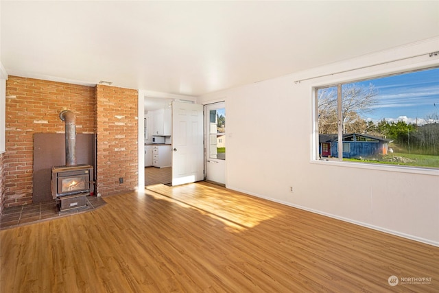 735 Harbor St, Friday Harbor, WA 98250 - unfurnished living room with hardwood / wood-style flooring and a wood stove