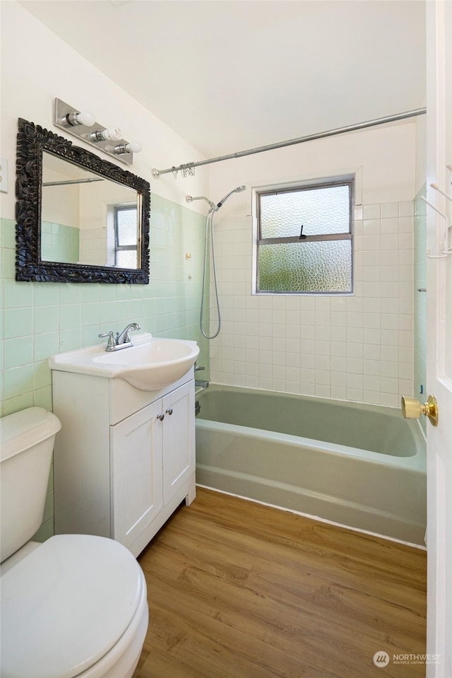 735 Harbor St, Friday Harbor, WA 98250 - full bathroom with vanity, a wealth of natural light, hardwood / wood-style floors, and tile walls