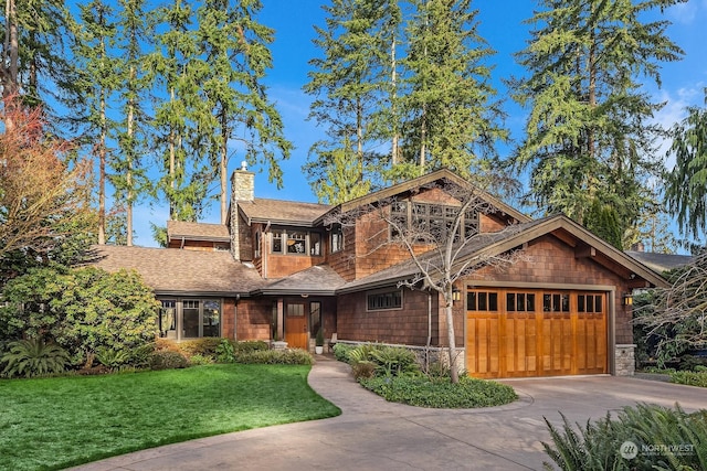 view of front of home featuring a garage and a front yard