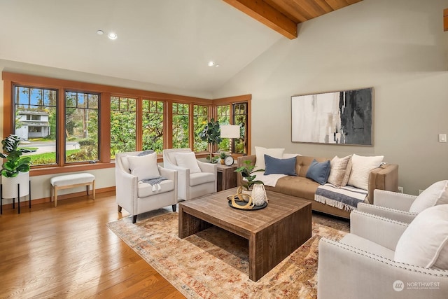 living room featuring light hardwood / wood-style floors and vaulted ceiling with beams