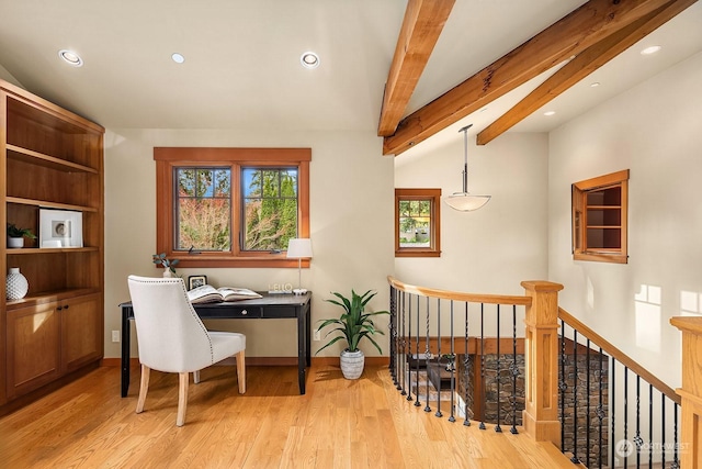 home office featuring lofted ceiling with beams and light wood-type flooring