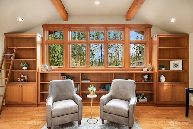 living area featuring light hardwood / wood-style flooring and lofted ceiling with beams