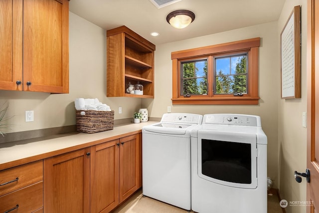 laundry area with cabinets and separate washer and dryer