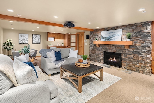 living room featuring a fireplace, sink, beamed ceiling, and light carpet