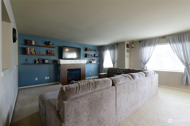 carpeted living room with a wealth of natural light and a fireplace