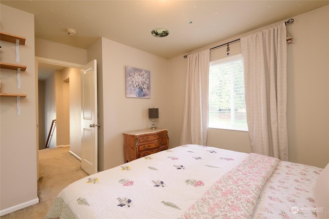 bedroom featuring light carpet