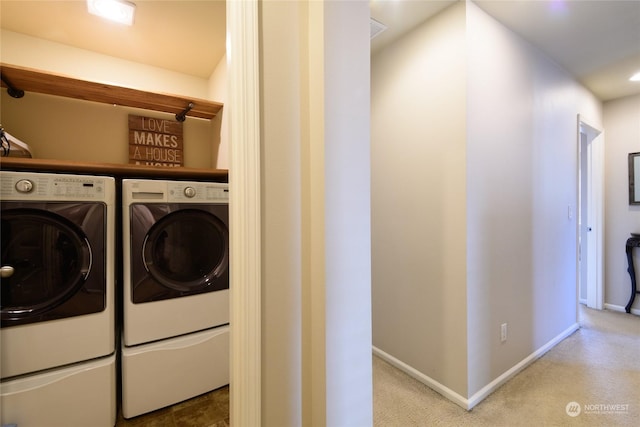 washroom with washer and clothes dryer and carpet flooring