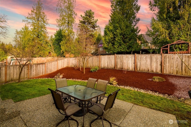 patio terrace at dusk with a lawn