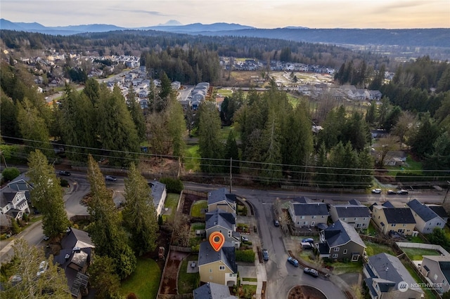 aerial view at dusk featuring a mountain view