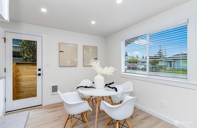 dining space featuring light wood-type flooring