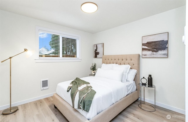 bedroom with hardwood / wood-style floors