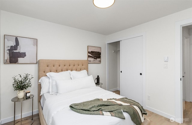 bedroom featuring hardwood / wood-style floors and a closet