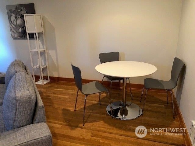 dining room with dark wood-type flooring