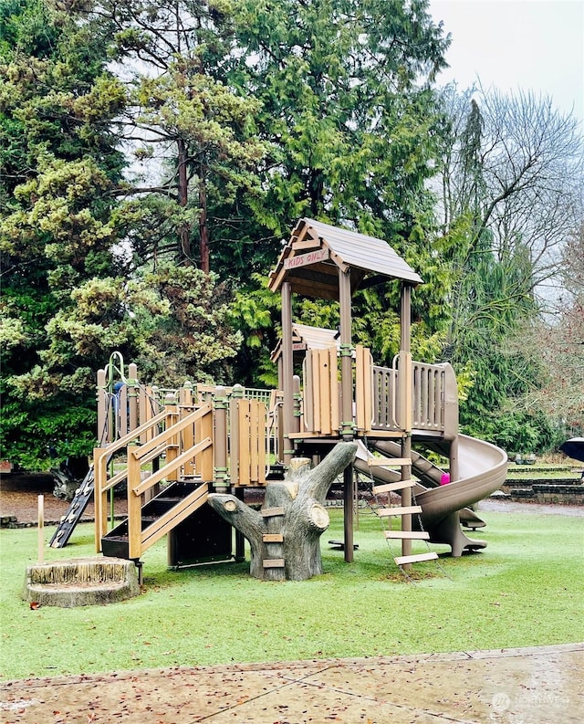 view of playground with a lawn