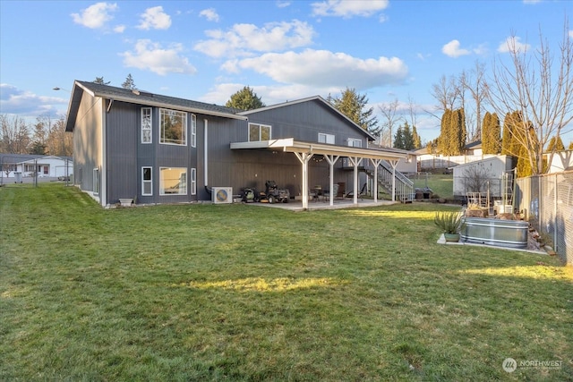 back of house featuring ac unit, a patio, and a lawn