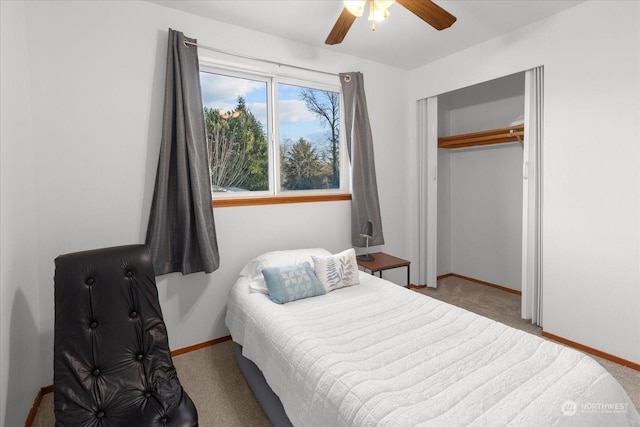 bedroom featuring light colored carpet, a closet, and ceiling fan