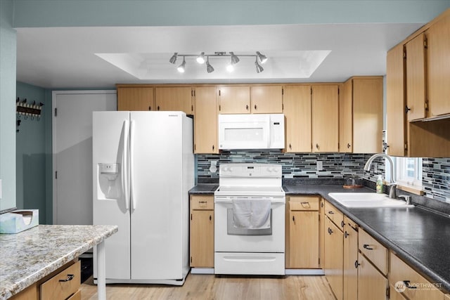 kitchen with sink, decorative backsplash, light hardwood / wood-style floors, a raised ceiling, and white appliances