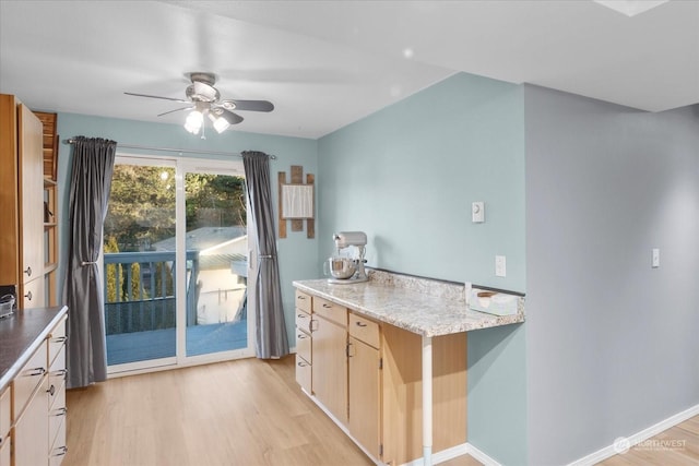 kitchen with ceiling fan, light stone countertops, light wood-type flooring, and light brown cabinetry