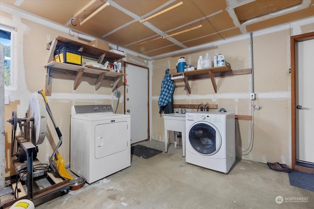 clothes washing area featuring washer and clothes dryer