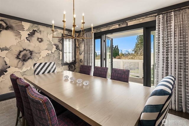 dining area with wood finished floors and a chandelier