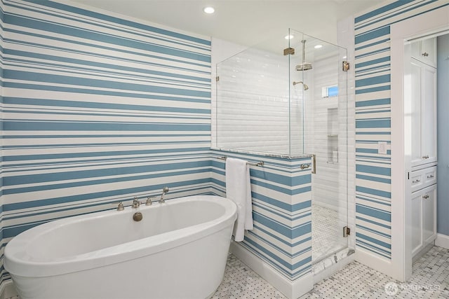 bathroom featuring wallpapered walls, a shower stall, recessed lighting, and a freestanding bath