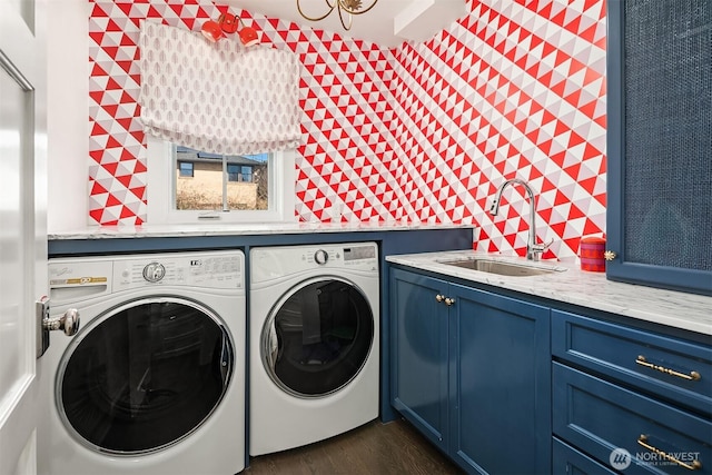 washroom featuring cabinet space, independent washer and dryer, dark wood-style flooring, and a sink