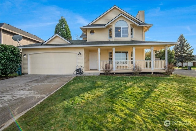 view of front of property featuring a garage, a front yard, and a porch