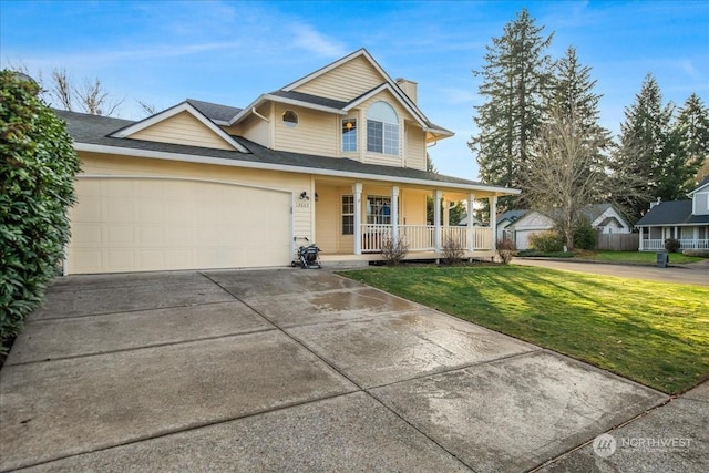 view of front of home with a front yard, a porch, and a garage