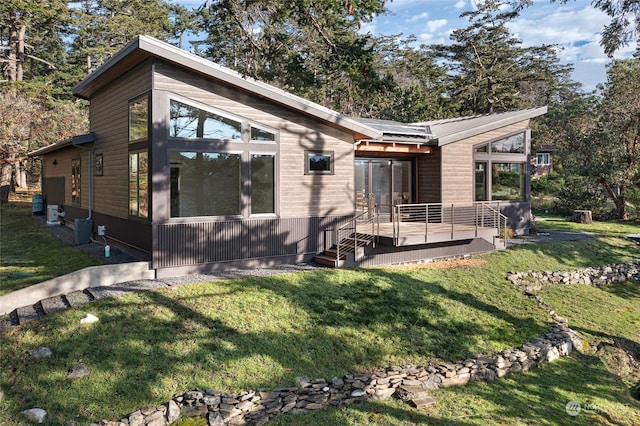 view of front of house featuring a deck and a front lawn