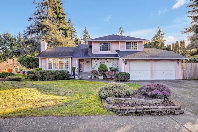 front of property featuring a garage and a front lawn