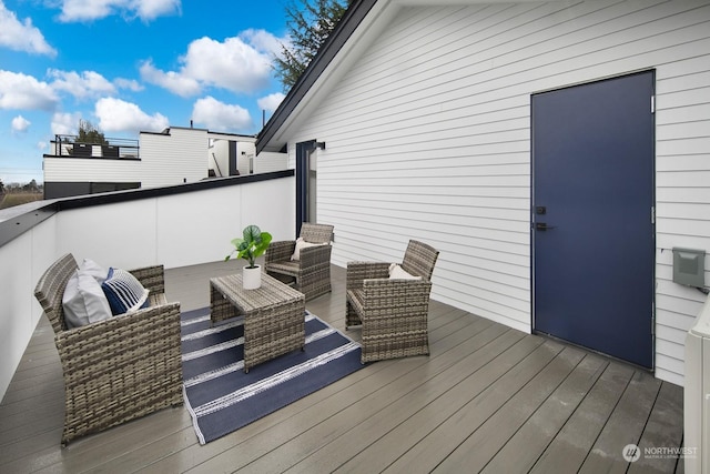 wooden terrace featuring an outdoor hangout area