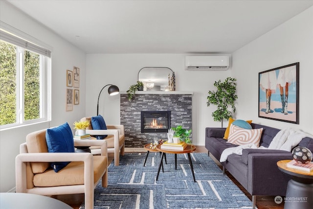 living room featuring a fireplace, hardwood / wood-style floors, and a wall mounted air conditioner