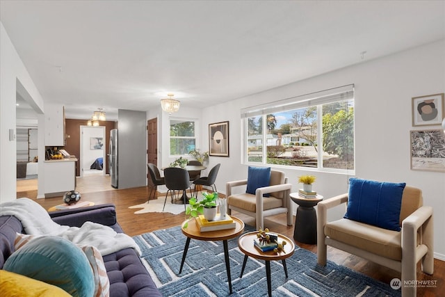 living room featuring light hardwood / wood-style flooring and an inviting chandelier