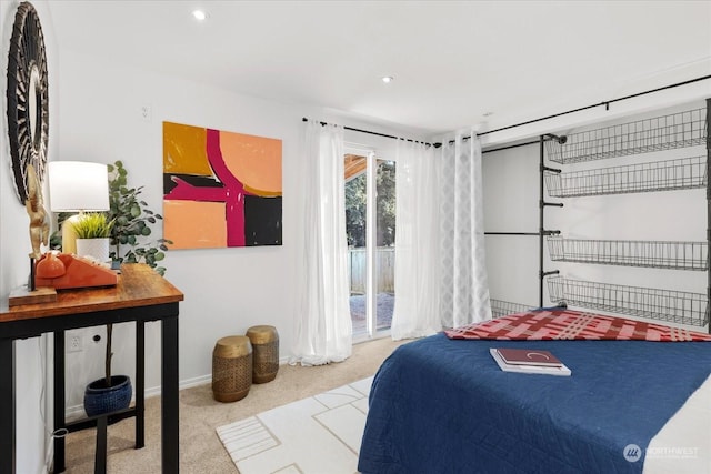 bedroom with light colored carpet and access to outside