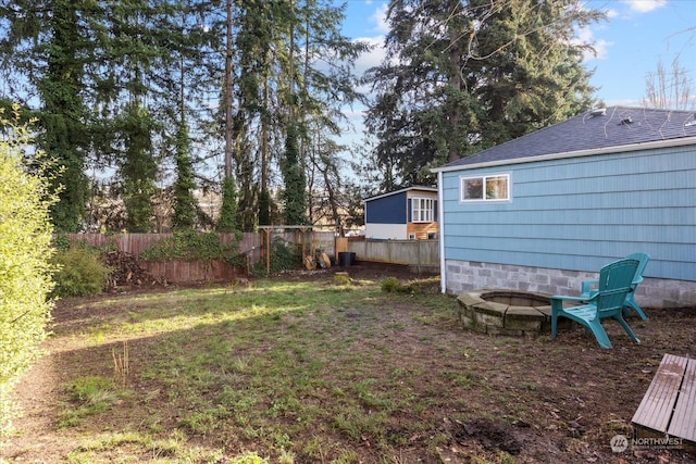 view of yard with an outdoor fire pit