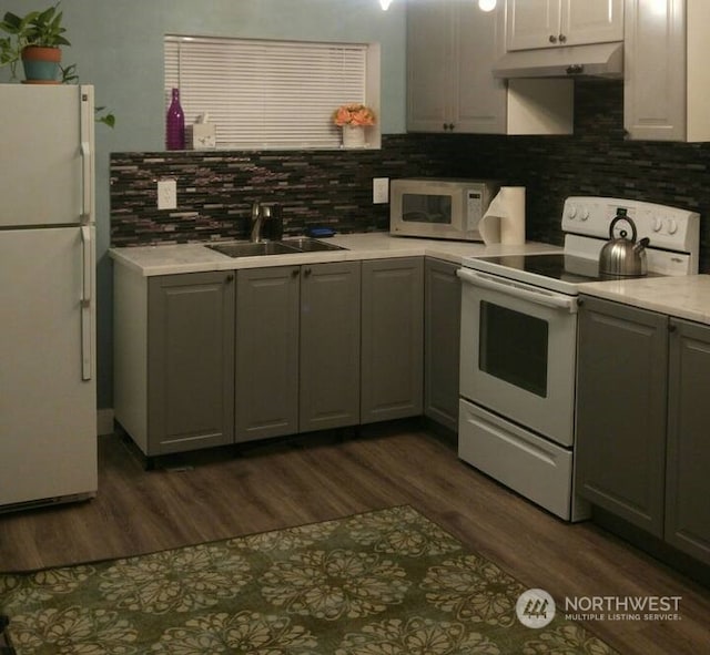 kitchen featuring sink, white appliances, and gray cabinets