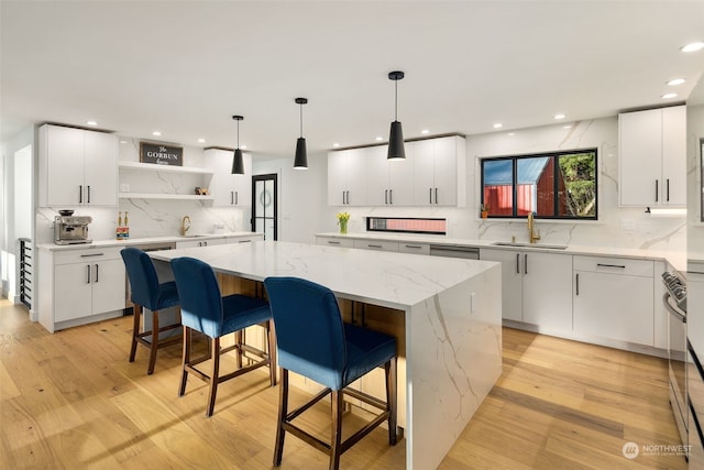 kitchen with white cabinets, sink, and a center island